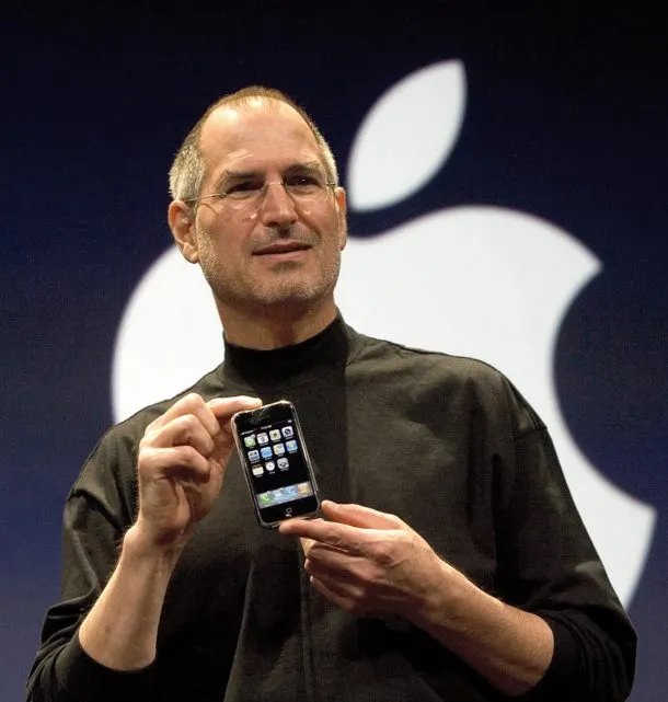 A picture of Steve Jobs holding the first iPhone